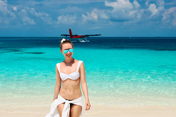 istock Woman at beach. Seaplane at background. 537927467