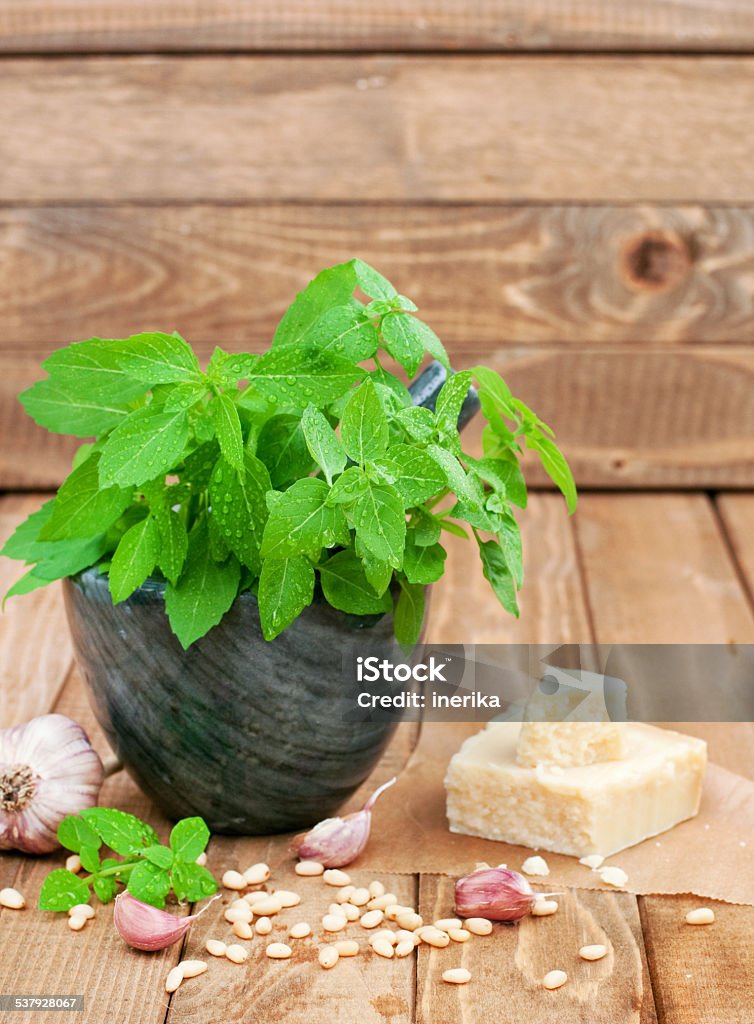 preparation pesto Fresh basil and another ingredients for preparation pesto sauce on wooden table, vertical 2015 Stock Photo