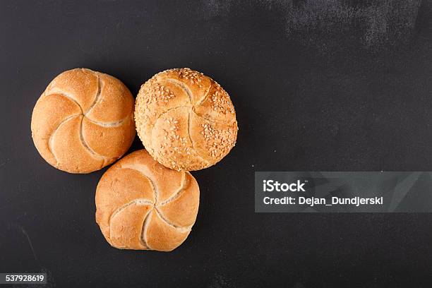 Kaiser Bread On Dark Chalkboard Stock Photo - Download Image Now - Kaiser Mountains, Bread, Bun - Bread