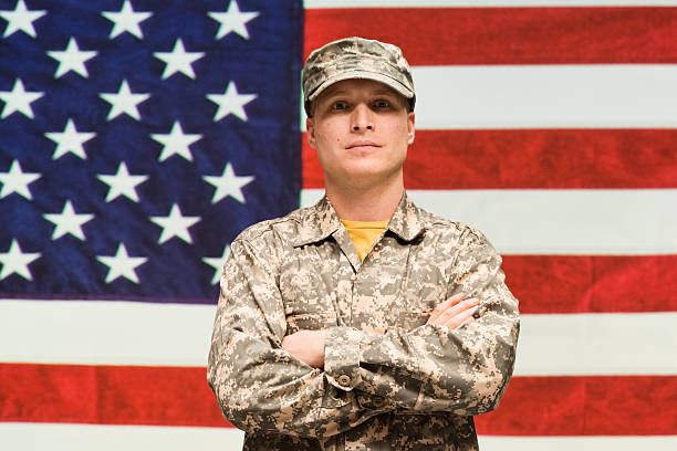 istock Army man in front of American flag 537929353