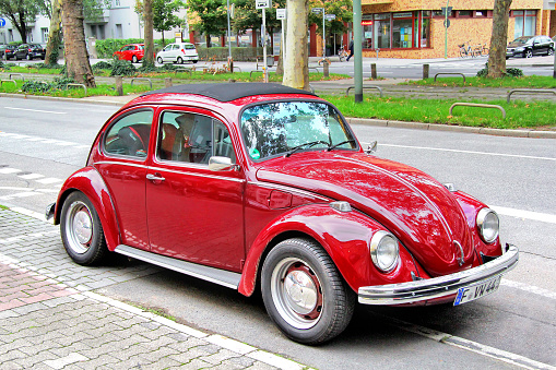 Frankfurt am Main, Germany - September 15, 2013: Cherry Volkswagen Beetle retro car parked at the city street.