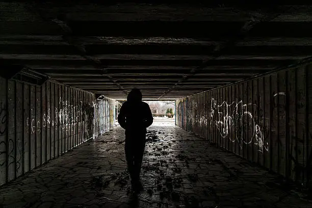 Photo of Silhouette of a man in tunnel
