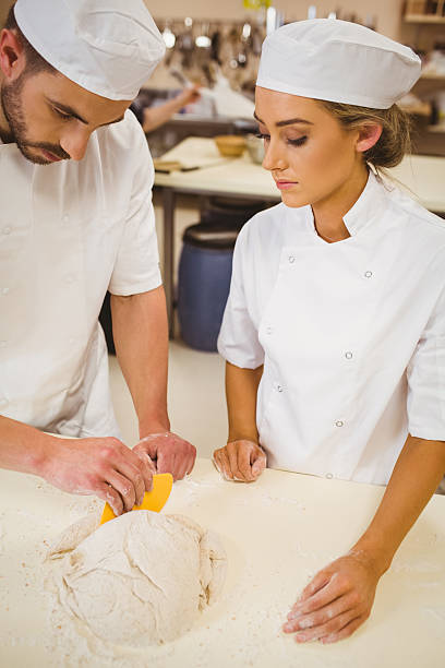istock Team of bakers preparing dough 537953677