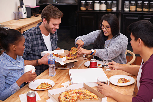 Cropped shot of a group of friends enjoying pizza together