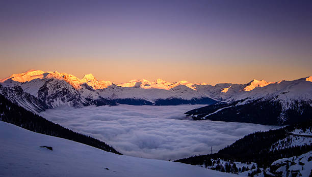istock Sunset over foggy valley in the Alps 537971577