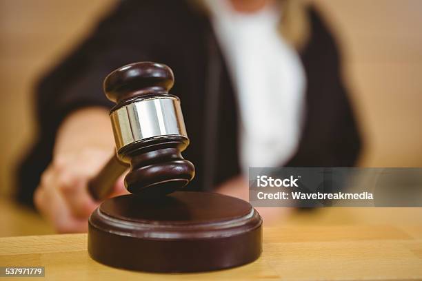 Hand About To Bang Gavel On Sounding Block Stock Photo - Download Image Now - Courthouse, Judge - Law, Gavel