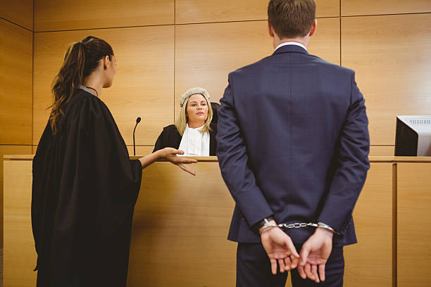 istock Judge talking with the criminal in handcuffs 537971835