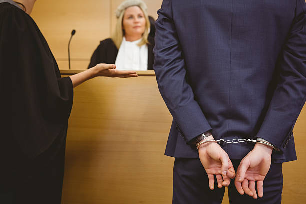 istock Judge talking with the criminal in handcuffs 537971837