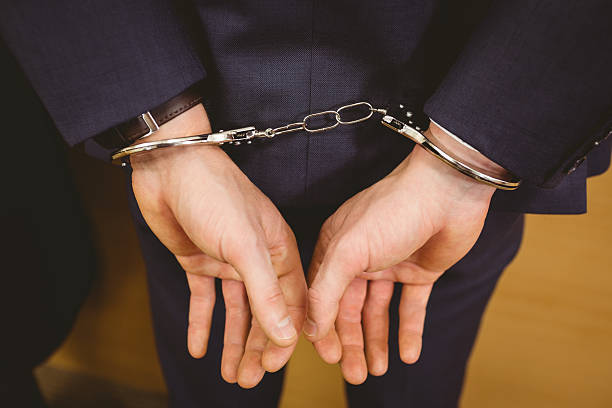 istock Hands of businessman with handcuffs 537971863