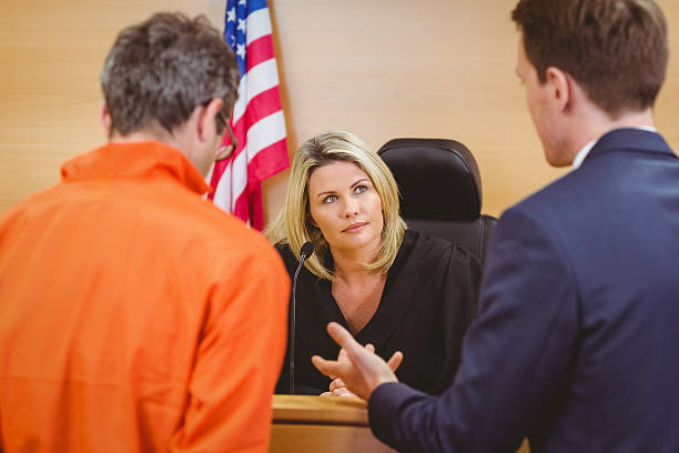 istock Lawyer speaking about the criminal in orange jumpsuit 537971877