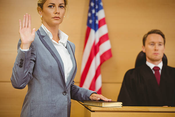 istock Witness swearing on bible telling the truth 537972261