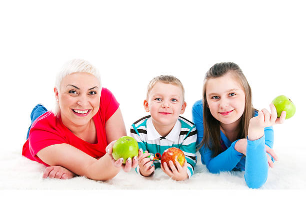 Young mother with two children Young mother with two children on a white background 10 11 years photos stock pictures, royalty-free photos & images