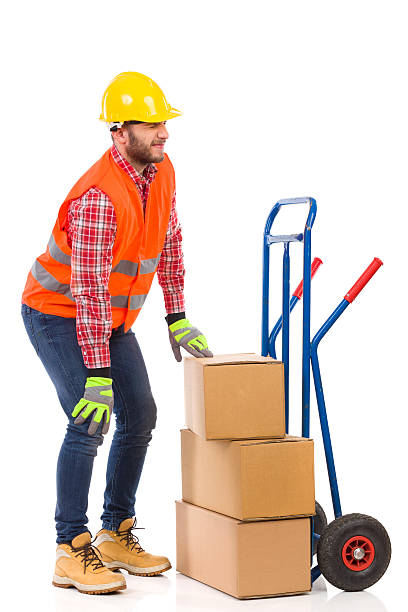 Accident at work Manual worker holding knee in pain. Full length studio shot isolated on white. mover delivery person box hand truck stock pictures, royalty-free photos & images