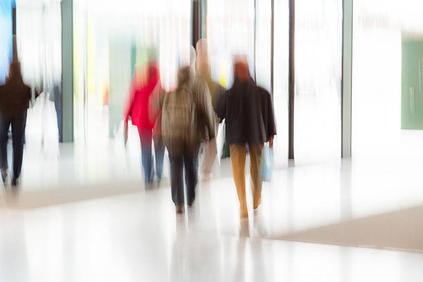 istock Motion Blurred People Waling in Lobby 537974653