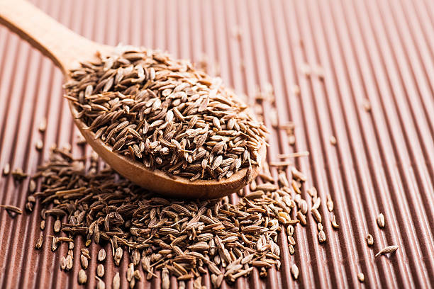 istock spice cumin in a wooden spoon 537975283