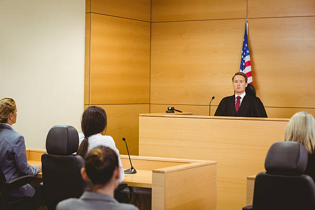 istock Unsmiling judge with american flag behind him 537975583