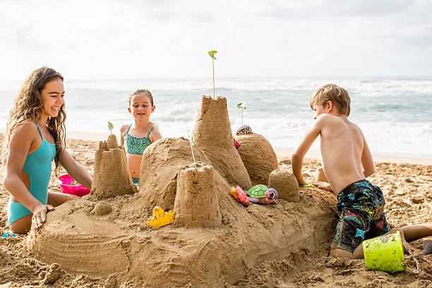 istock Siblings building sandcastle on vacation to a tropical destinati 537975607