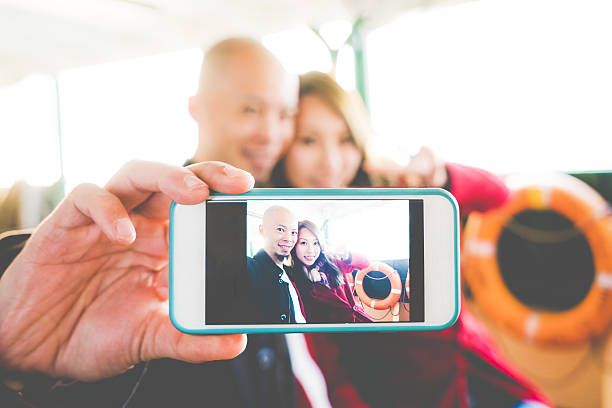 istock Couple Taking Selfie On A Ferry 537975649
