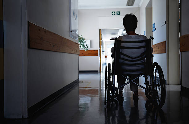 There's always light at the end of the tunnel Rearview shot of a senior woman sitting in a wheelchair medical supplies wheelchair medical equipment nursing home stock pictures, royalty-free photos & images