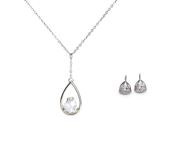 istock beautiful silver necklace and diamond earrings isolated on white 537976139