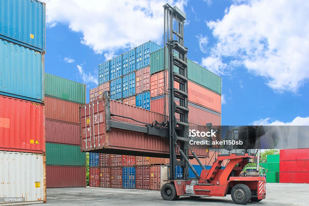 Crane lifter handling container box loading to depot Crane - Machinery Stock Photo