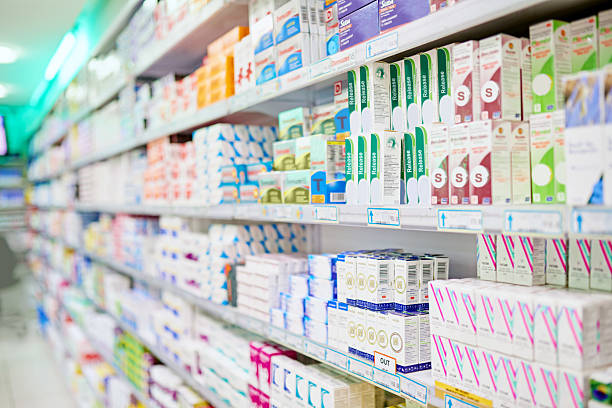 Everything for your ailments An aisle in a pharmacy. The commercial product(s) or designs displayed in this image represent simulations of a real product, and are changed or altered enough so that they are free of any copyright infringements. Our team of retouching and design specialists custom designed these elements for each photo shoot chemist stock pictures, royalty-free photos & images