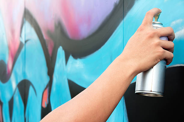 istock Hand holding spray paint on the wall graffiti 537987331