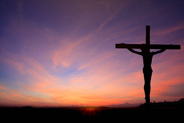 istock Jesus on cross wtih two prisons in sunrise sky 538012761