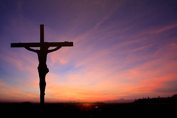 istock Jesus on cross wtih two prisons in sunrise sky 538012775