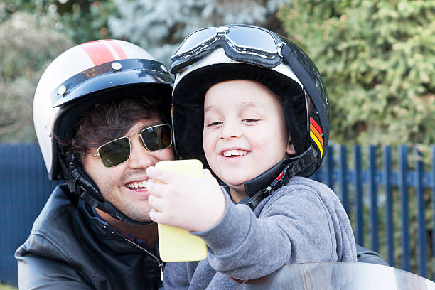 istock father and son motorcyclists take a selfie on the road 538013185