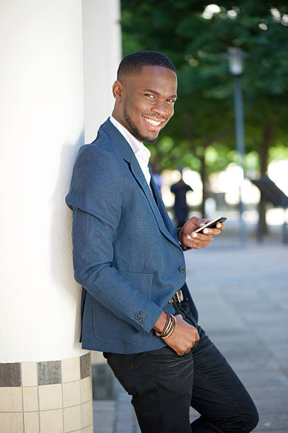 istock Cool businessman sending text message by mobile phone 538016731