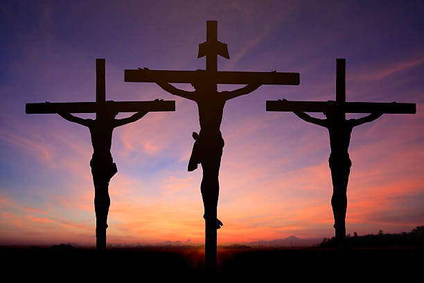 istock Jesus on cross wtih two prisons in sunrise sky 538016949