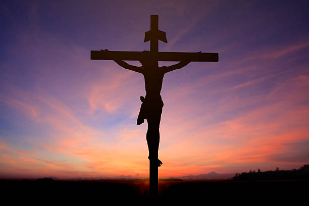 istock Jesus on cross wtih two prisons in sunrise sky 538016957
