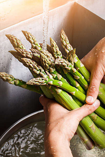 istock Male hands wash asparagus. 538026154