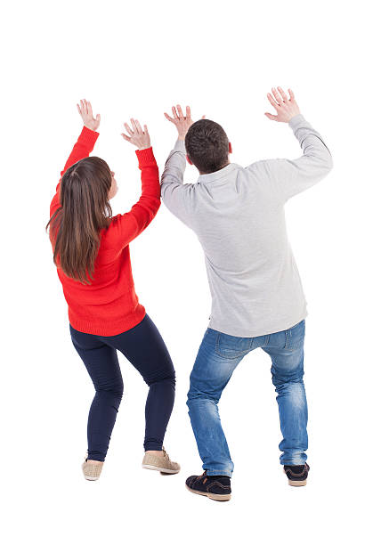 Back view of young embracing couple (man and woman Back view of young embracing couple (man and woman) Ducked protecting yourself from the danger of hands. beautiful friendly girl and guy together. Rear view people collection. backside view of person. Isolated over white background. pics of girls buttocks stock pictures, royalty-free photos & images