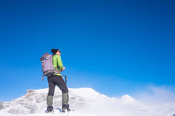 istock Hiker on top of snowy mountain 538030450