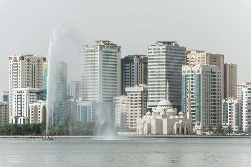 Cityscape of Sharjah with mosque and fountain, UAE