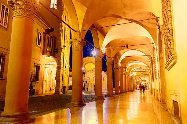 view of Piazza Santo Stefano (Bologna) in the evening, from the arcades of the square