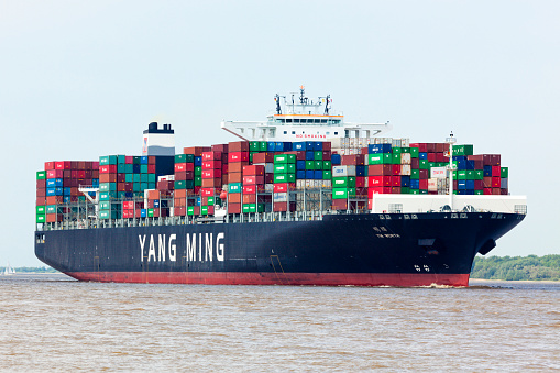 Stade, Germany - May 22, 2016: Ultra Large Container Ship YM Worth on the Elbe river near Hamburg. YM Worth can hold 14,080 TEU, is 368 meters long and operated by chinese shipping company Yang Ming Lines, Keelung.