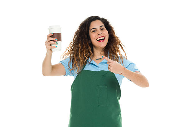 istock Smiling female janitor pointing at coffee cup 538035116