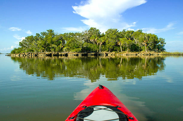 istock Red Kayak and Desert Island Reflected in Calm Water 538036365
