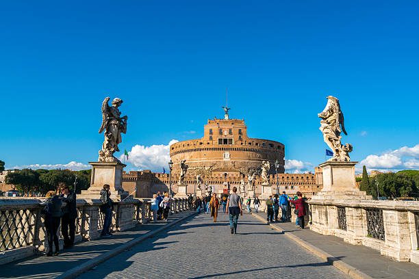 Rome, Italy - March 1, 2016: View of Castel Sant'Angelo from St. Angelo Bridge in Rome, Italy. People can be seen walking around.