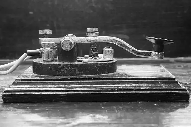 old morse key telegraph on wood table