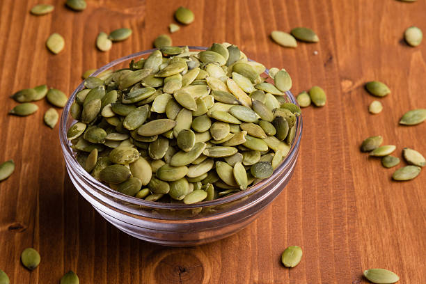 istock pumpkin seeds in a glass bowl 538037148
