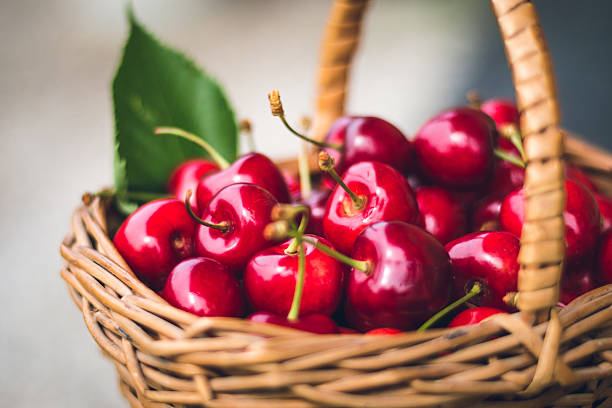Cherries in a basket Cherries in a basket cherry photos stock pictures, royalty-free photos & images