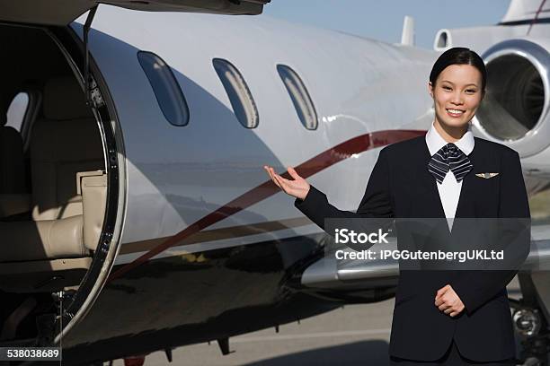 Flight Attendant In Front Of Private Jet Stock Photo - Download Image Now - 2015, 30-34 Years, Adult