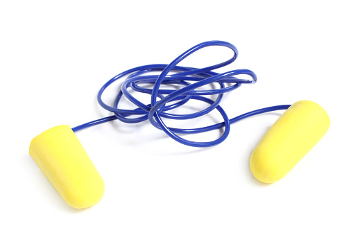Yellow earplugs with blue band on white background