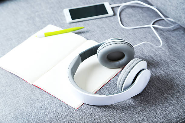 istock Headphones with smartphone on a grey sofa 538040828