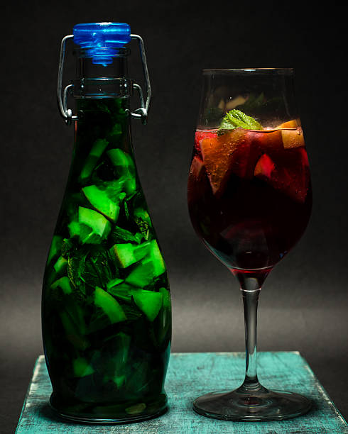 summer bright green red fruit cocktail in glass, lemonade, studio