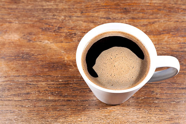 istock Coffee mug on an old wooden table - copy space. 538042137
